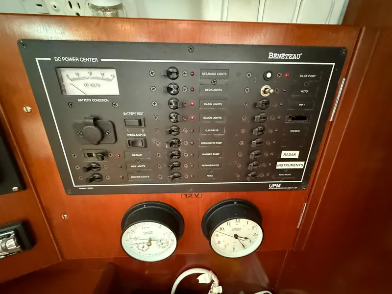 Slide: The Image of Electrical control panel of a 2003 Beneteau 393 sailboat, featuring various switches and gauges. - 40
