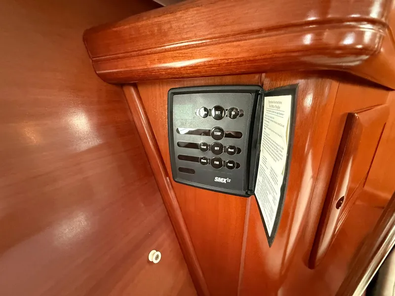 Slide: The Image of Control panel on 2003 Beneteau 393 yacht's wooden interior. - 42
