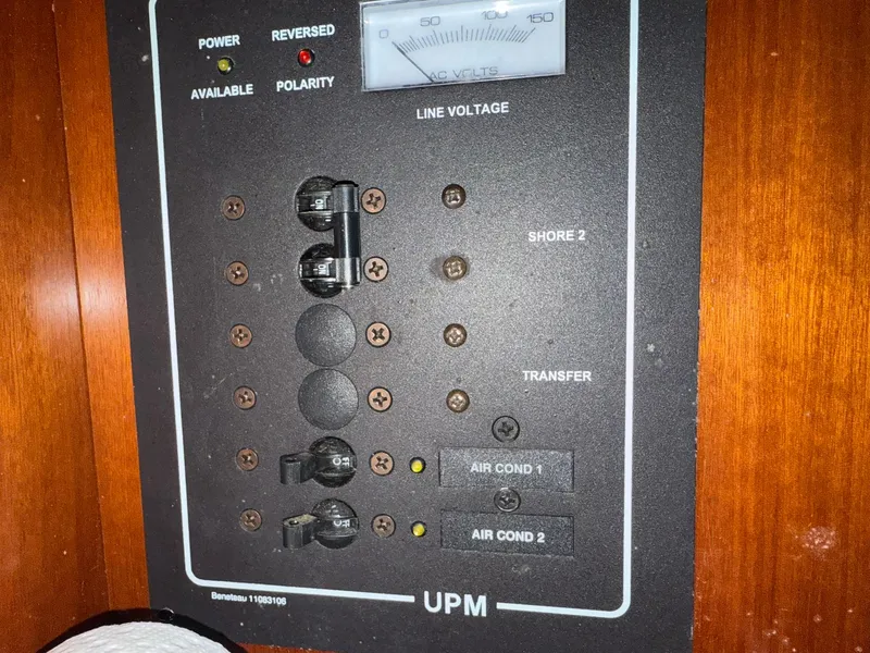 Slide: The Image of Electrical panel of a 2003 Beneteau 393 sailboat, showing line voltage and circuit breakers. - 44