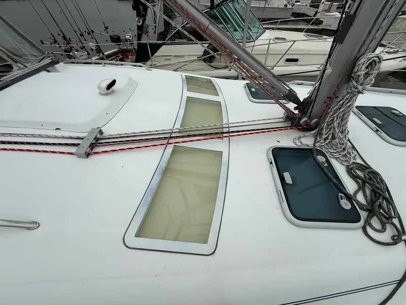 Slide: The Image of Deck of a 2003 Beneteau 393 sailboat with rigging and hatches. - 9