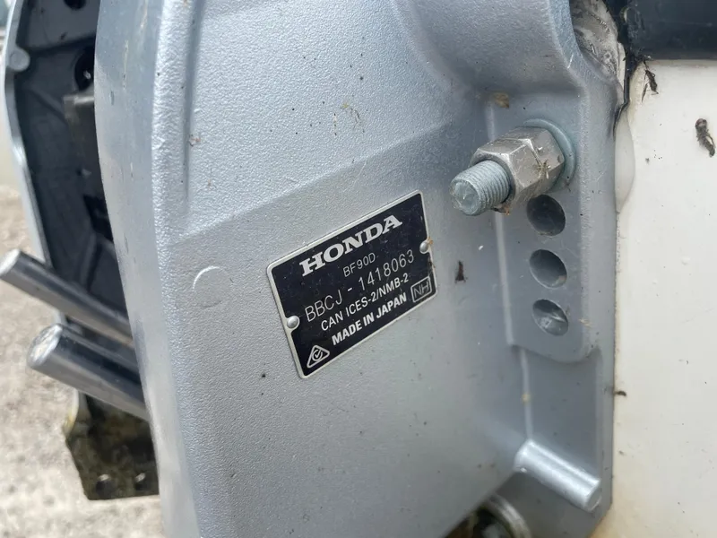 Slide: The Image of Honda BF90D engine plate on a 2008 Boston Whaler 170 Montauk boat. - 15