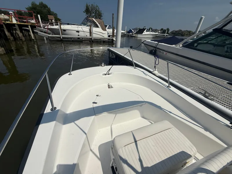 Slide: The Image of 2008 Boston Whaler 170 Montauk boat docked at marina, sunny day. - 5
