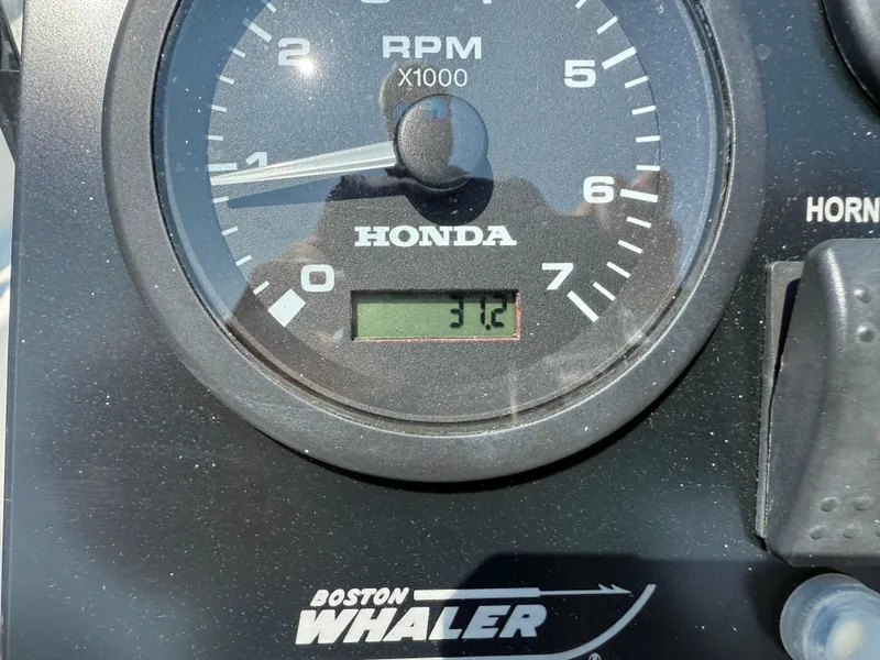 Slide: The Image of Close-up of a 2008 Boston Whaler 170 Montauk RPM gauge displaying 312. - 9