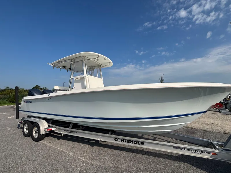 Slide: The Image of 2012 Contender 28 Sport boat on trailer under clear blue sky. - 10