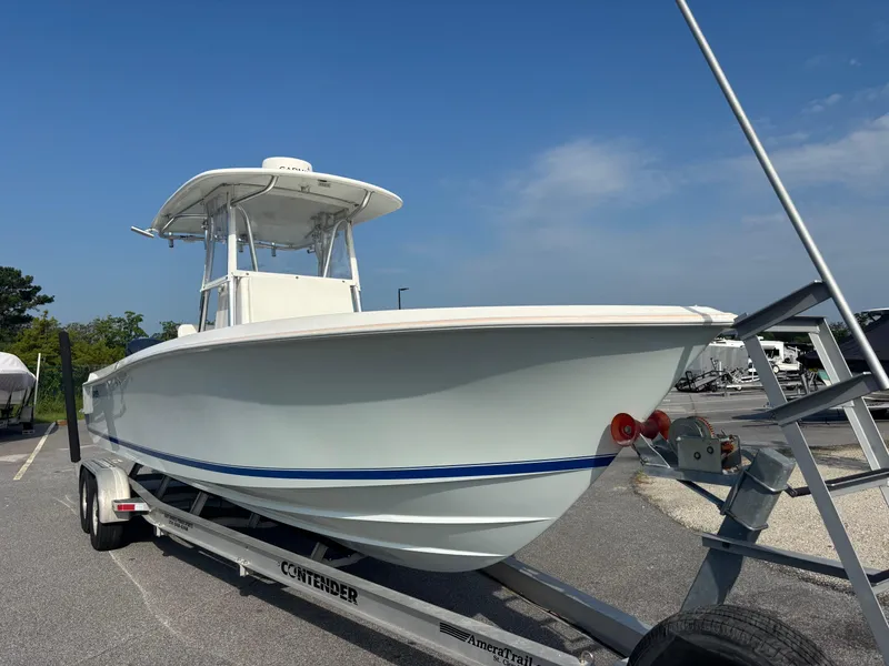 Slide: The Image of 2012 Contender 28 Sport boat on trailer under clear blue sky. - 11