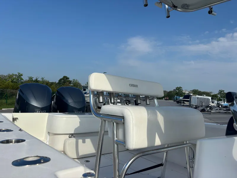 Slide: The Image of 2012 Contender 28 Sport boat with dual engines and white seating under a clear sky. - 12