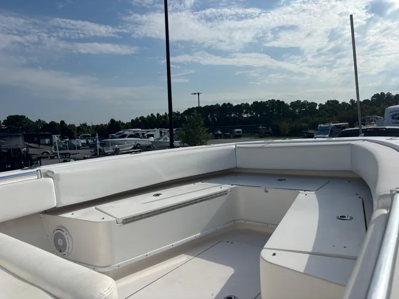 Slide: The Image of 2012 Contender 28 Sport boat interior with white seating under a clear sky. - 14