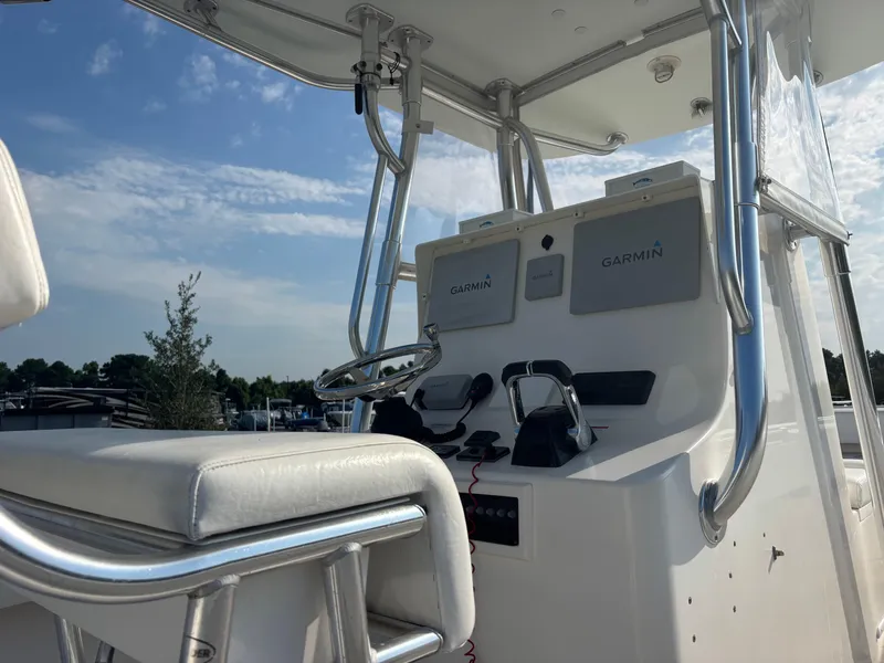 Slide: The Image of 2012 Contender 28 Sport boat console with Garmin navigation, stainless steel frame, and seating. - 15