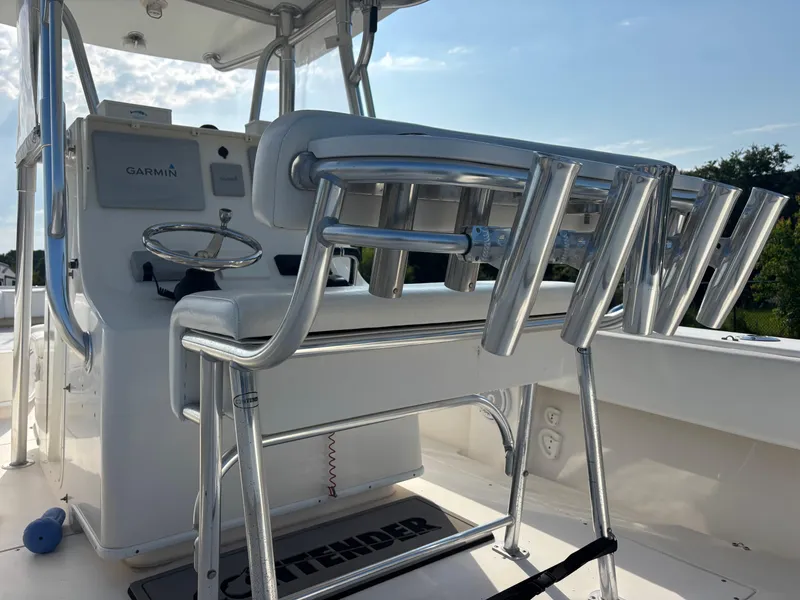 Slide: The Image of 2012 Contender 28 Sport boat cockpit with Garmin equipment and rod holders. - 16