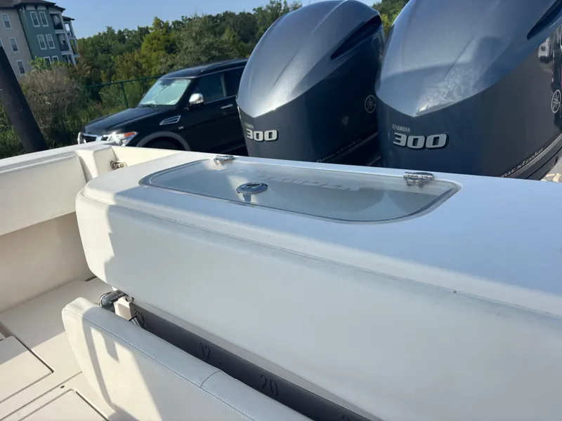 Slide: The Image of Contender 28 Sport 2012 boat with dual Yamaha 300 engines, parked near a vehicle. - 17