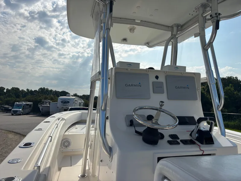 Slide: The Image of 2012 Contender 28 Sport boat with Garmin navigation, docked under a cloudy sky. - 18