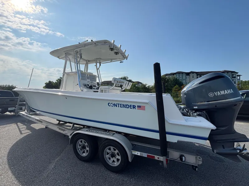 Slide: The Image of 2012 Contender 28 Sport boat on trailer with Yamaha engine, parked outdoors. - 5