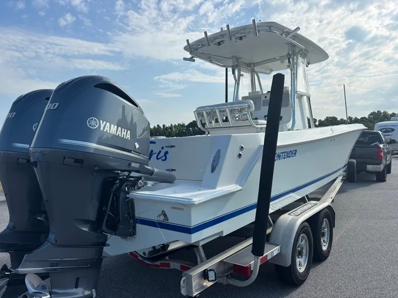 Slide: The Image of 2012 Contender 28 Sport boat with dual Yamaha engines on a trailer. - 8