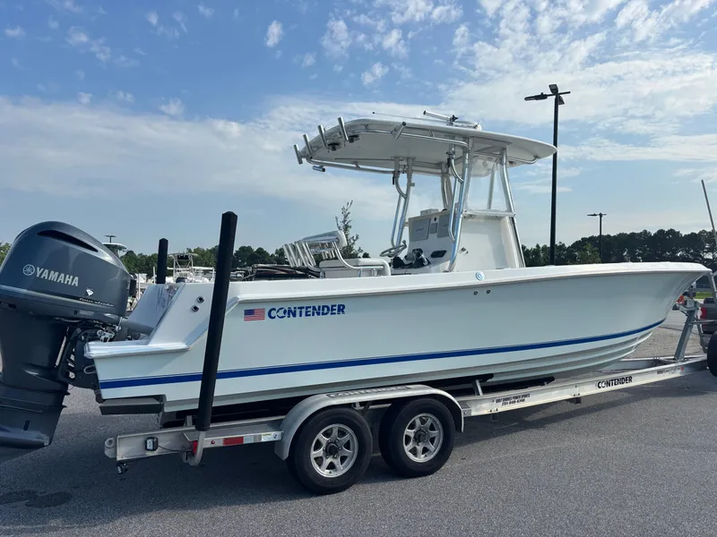 Slide: The Image of 2012 Contender 28 Sport boat on trailer with Yamaha engine, parked outdoors. - 9