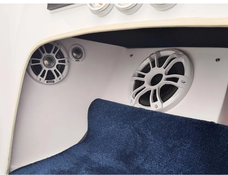 Slide: The Image of Interior of 2005 Donzi boat featuring Fusion speakers and blue carpet. - 12
