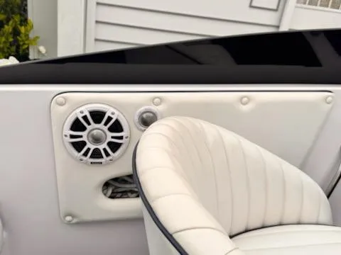 Slide: The Image of 2005 Donzi boat interior with white leather seat and speaker system. - 11