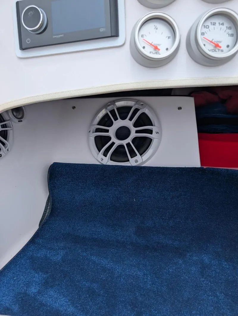 Slide: The Image of 2005 Donzi boat dashboard with gauges, speaker, and blue carpet. - 14