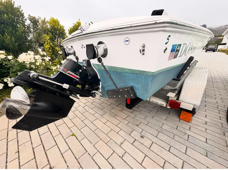 Slide: The Image of 2005 Donzi boat on trailer with Mercury outboard, parked on brick driveway. - 22