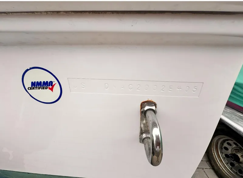 Slide: The Image of 2005 Donzi boat with NMMA certification sticker and metal hook. - 23
