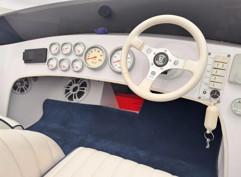 Slide: The Image of 2005 Donzi boat dashboard with gauges, steering wheel, and controls. - 5