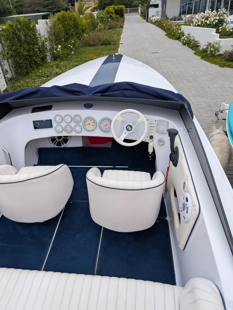 Slide: The Image of 2005 Donzi boat interior with white seats, dashboard, and steering wheel. - 9