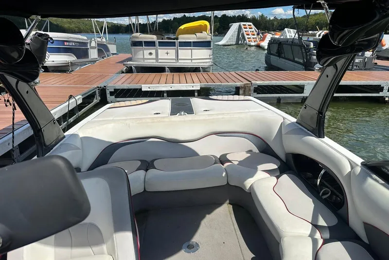Slide: The Image of 2008 Malibu Wakesetter VTX interior at a dock with boats and water activities. - 16