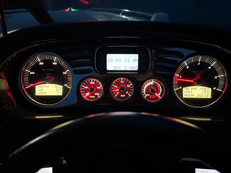 Slide: The Image of Dashboard of a 2008 Malibu Wakesetter VTX boat with illuminated gauges at night. - 9