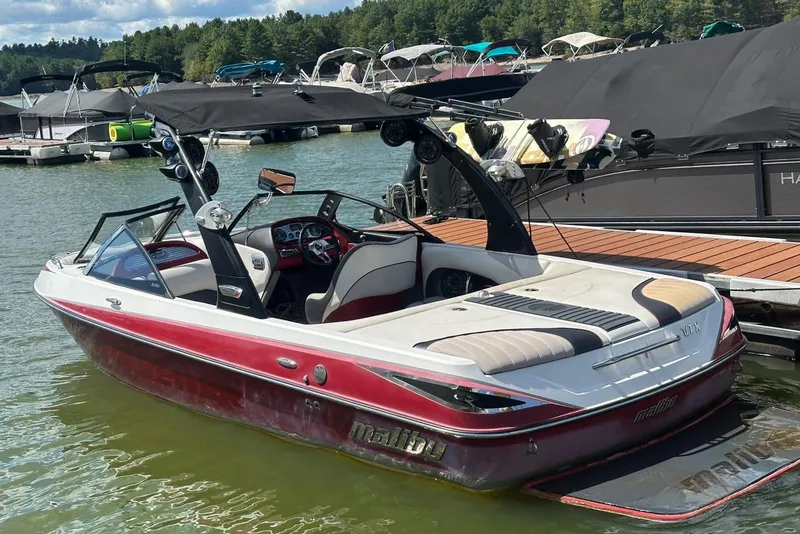 Slide: The Image of 2008 Malibu Wakesetter VTX boat docked on a sunny day. - 14