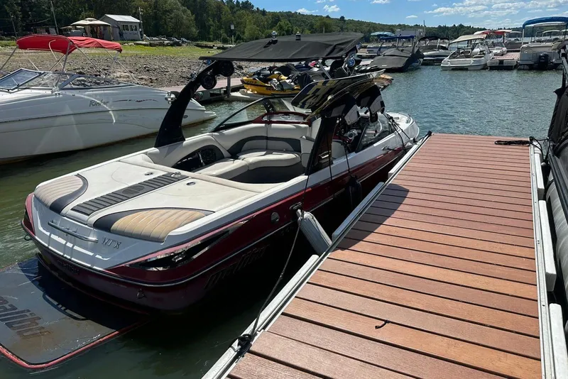 Slide: The Image of 2008 Malibu Wakesetter VTX docked at a marina with other boats. - 20