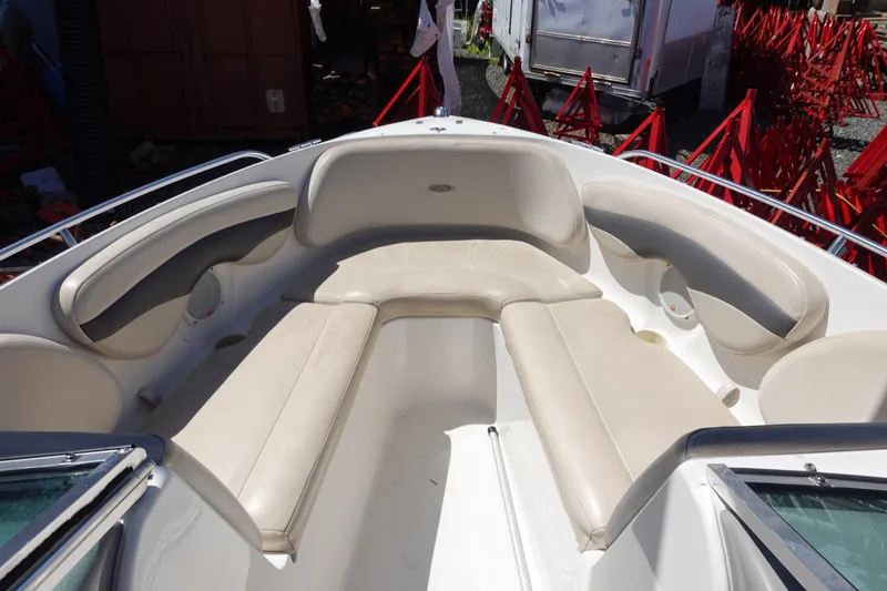 Slide: The Image of 2004 Chaparral 210 SSi boat interior with beige seating and cup holders. - 3