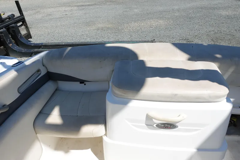 Slide: The Image of 2004 Chaparral 210 SSi boat interior with white seating and storage compartment. - 5