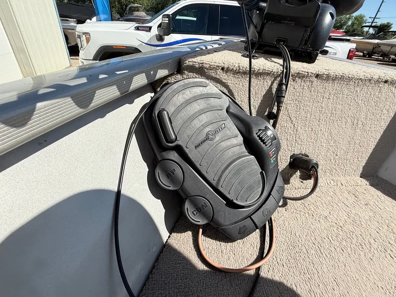 Slide: The Image of Foot pedal control on a 2005 Bass Tracker PGV16 boat, with visible wiring and carpeted surface. - 11