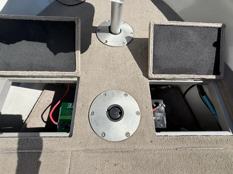 Slide: The Image of 2005 Bass Tracker PGV16 boat interior with open storage compartments and visible wiring. - 12