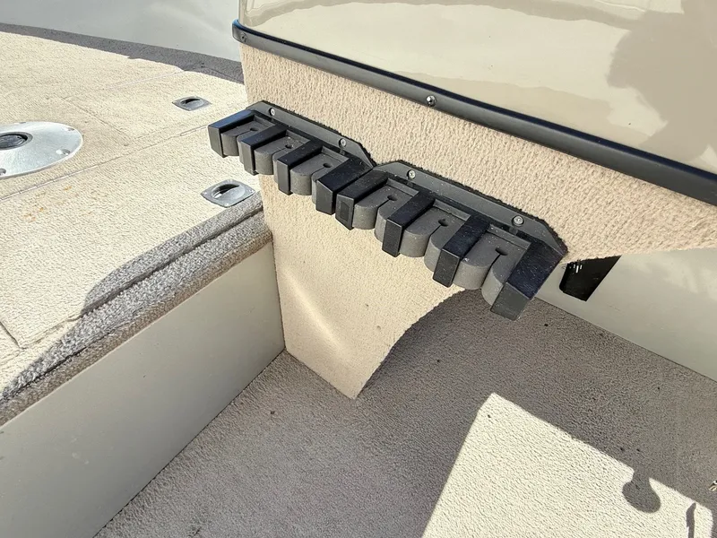 Slide: The Image of 2005 Bass Tracker PGV16 boat interior with rod holder and carpeted flooring. - 14