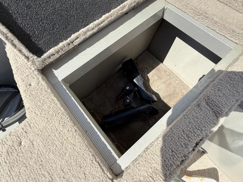 Slide: The Image of Open storage compartment in 2005 Bass Tracker PGV16 boat with carpeted interior. - 20
