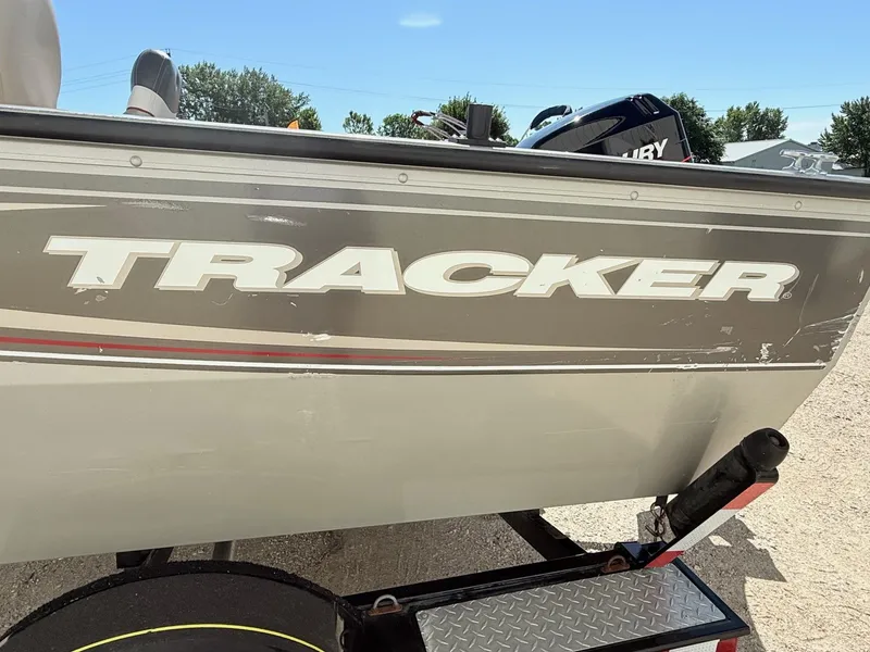 Slide: The Image of 2005 Bass Tracker PGV16 boat side view with logo, parked on a trailer. - 4