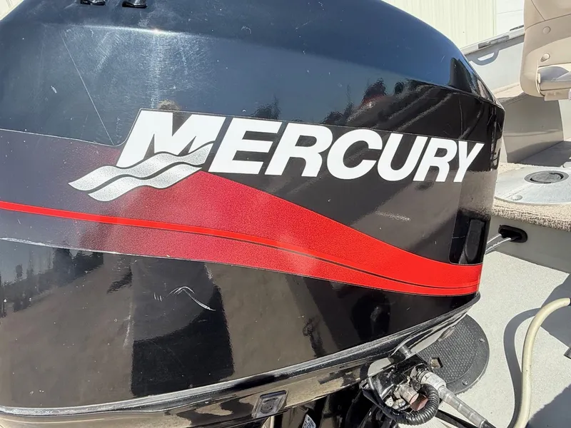 Slide: The Image of Mercury outboard motor on a 2005 Bass Tracker PGV16 boat, featuring a red stripe design. - 6