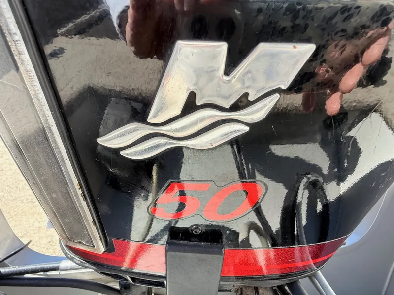 Slide: The Image of Close-up of a 2005 Bass Tracker PGV16 outboard motor with a "50" decal. - 7