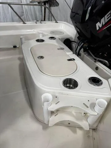 Slide: The Image of 2021 Boston Whaler 150 Montauk boat interior with engine and storage compartment. - 10