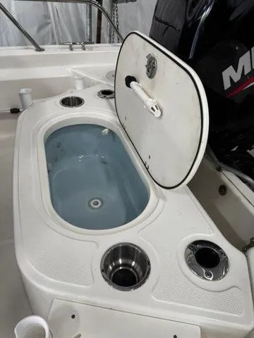 Slide: The Image of 2021 Boston Whaler 150 Montauk livewell and cup holders on deck. - 11