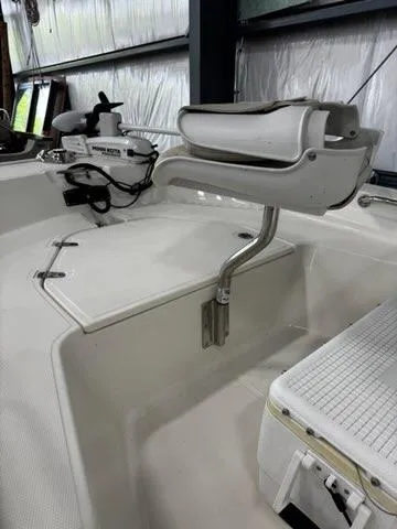 Slide: The Image of 2021 Boston Whaler 150 Montauk boat interior with mounted equipment in storage. - 12