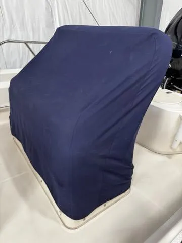 Slide: The Image of 2021 Boston Whaler 150 Montauk boat console covered with a navy blue fabric. - 14