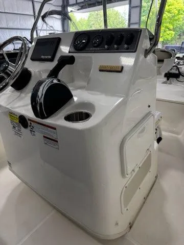 Slide: The Image of 2021 Boston Whaler 150 Montauk boat console with steering wheel and controls. - 18