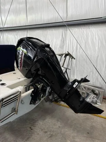 Slide: The Image of 2021 Boston Whaler 150 Montauk with Mercury outboard motor in a garage. - 2