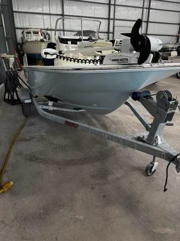 Slide: The Image of 2021 Boston Whaler 150 Montauk boat on trailer in storage facility. - 21