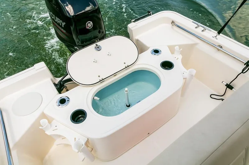 Slide: The Image of Manufacturer Provided Image: 2021 Boston Whaler 150 Montauk boat with open livewell and Mercury engine. - 26