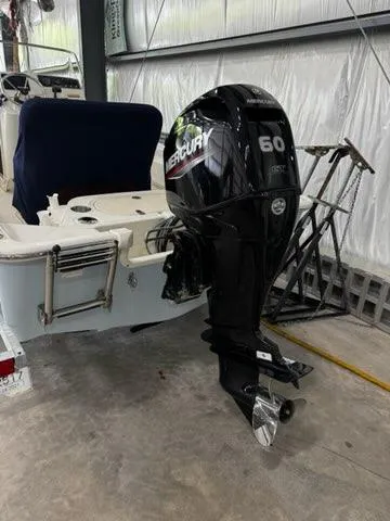 Slide: The Image of 2021 Boston Whaler 150 Montauk with Mercury 60 outboard motor in a storage facility. - 3