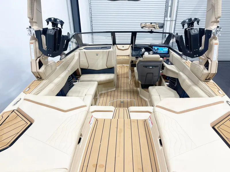 Slide: The Image of 2025 Nautique Super Air Nautique G25 interior with luxurious seating and advanced dashboard. - 5