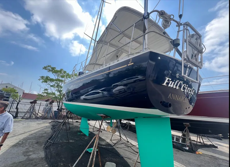 Slide: The Image of 1998 J Boats J/42 sailboat "Full Circle" on stands, Annapolis, clear sky background. - 10
