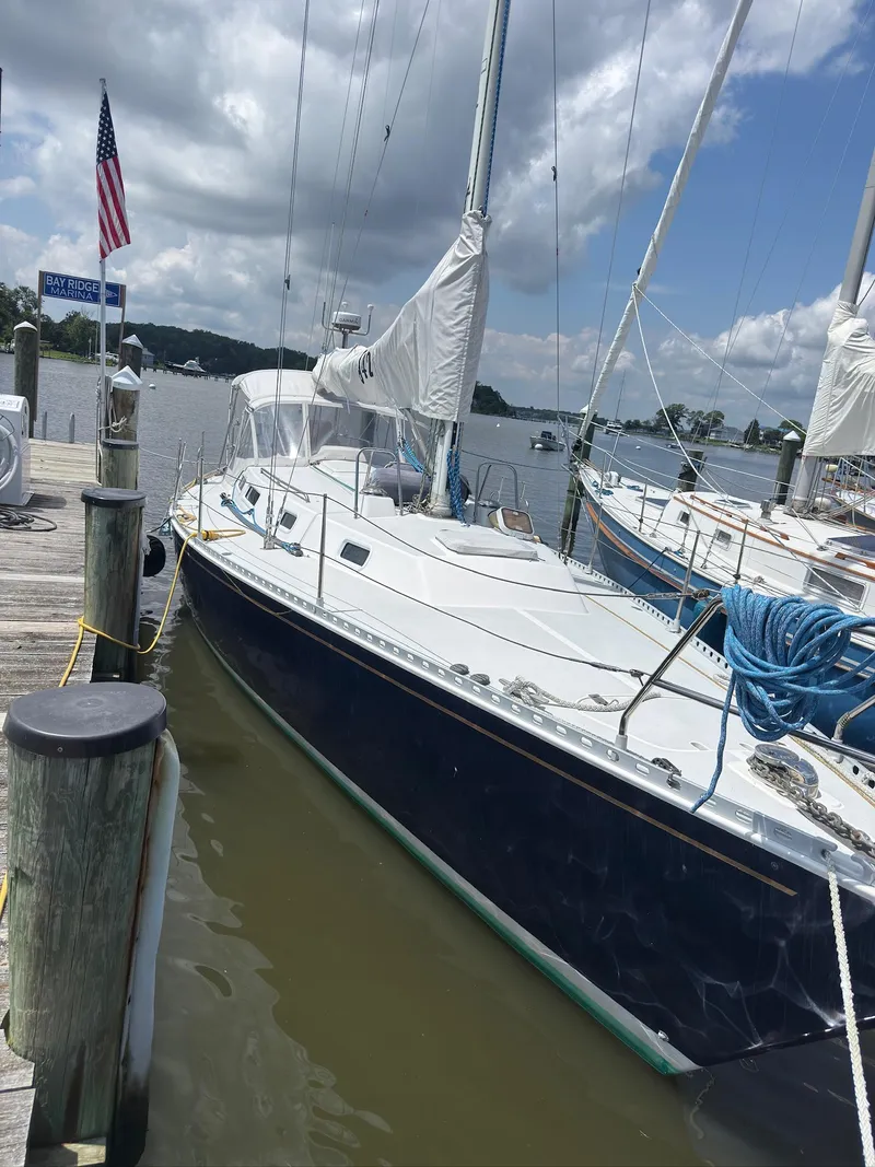 Slide: The Image of 1998 J Boats J/42 sailboat docked at marina under cloudy sky. - 11